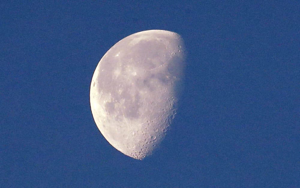 In this photo taken Dec. 27, 2018, the moon, in a waning gibbous phase and briefly visible on an otherwise cloudy day, is seen from Seattle. Despite the name of Pink Floyd's best-selling album, the side of the moon you can't see isn't always dark. But it is far. So scientists call the area where a Chinese spacecraft just landed the far side, not the dark side. (AP Photo/Elaine Thompson)