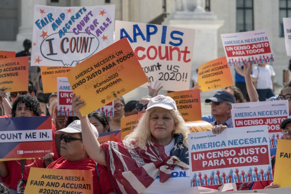 Immigration activists rally outside the Supreme Court on April 23 as the justices hear arguments over the Trump administration's plan to ask about citizenship on the 2020 census. (J. Scott Applewhite/AP)