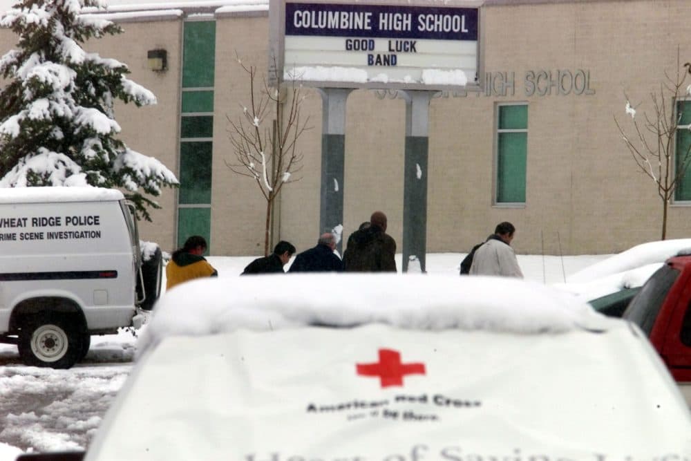 Police agents walk into Columbine High School in Littleton, Colorado, on April 23, 1999, where fourteen students and one teacher were killed a few days earlier. Two former students, Eric Harris and Dylan Klebold, opened fire on their classmates during what the police called a "suicide mission." (Hector Mata/AFP/Getty Images)