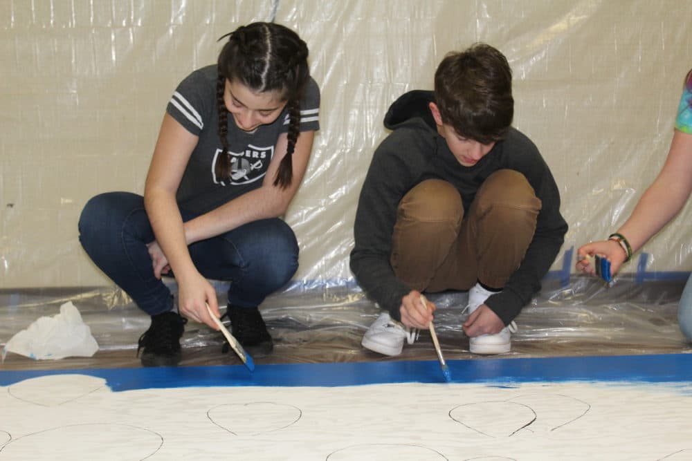 Students at Pine Ridge forget the Camp Fire and put their paint brushes to work. (Ashley Bailey/Here & Now)