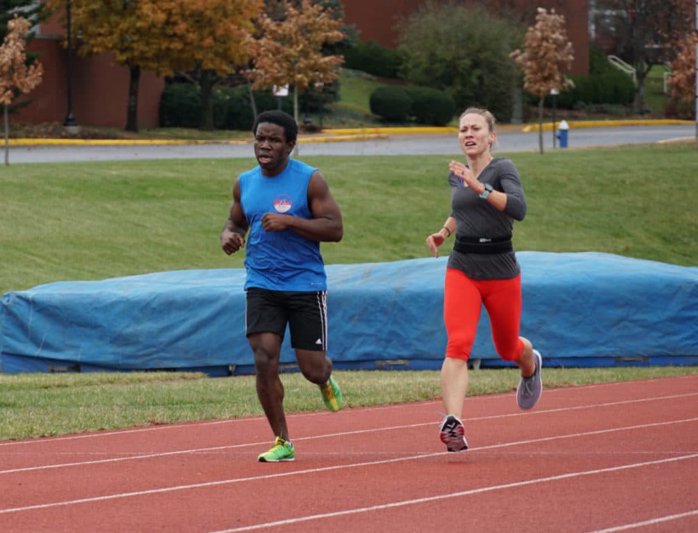 Nick Silver (left) runs alongside guide Liz Houghton. (Shahla Farzan for WBUR)