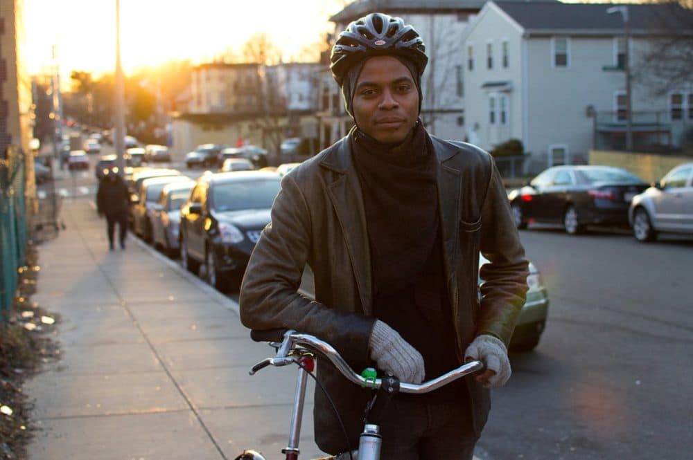 In this 2016 file photo, Noah De Amor stands with his bike outside Bowdoin Bike School in Dorchester. (Hadley Green for WBUR)