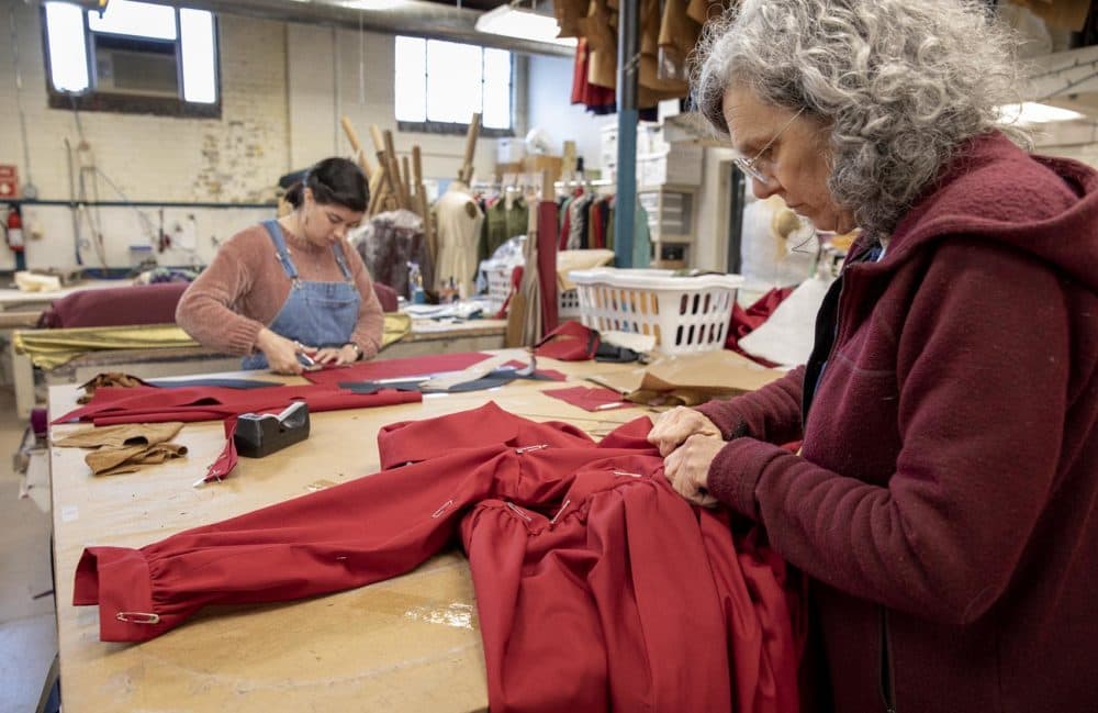 Therese Beck and Lila West work on costumes for the Boston Lyric Opera's production of "The Handmaid's Tale." (Robin Lubbock/WBUR)