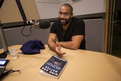 John Urschel with his new book "Mind And Matter." (Jesse Costa/WBUR)