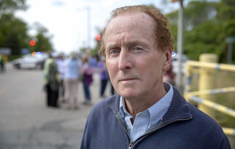 Activist Gerry Londergan joined other protesters gathered at the entrance to the Pilgrim nuclear plant ahead of the station's close. (Robin Lubbock/WBUR)