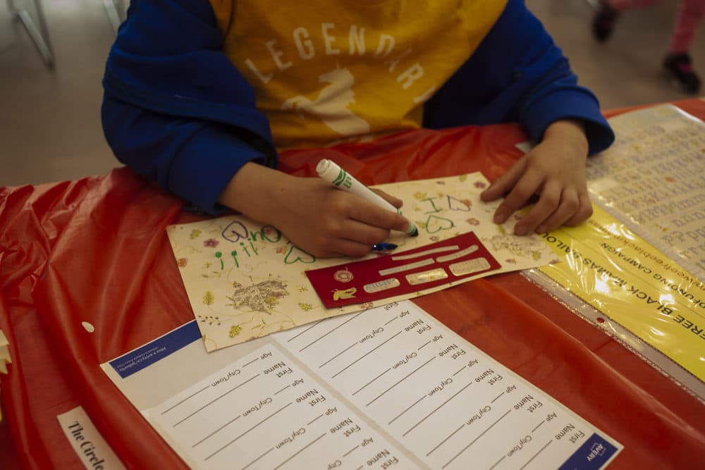 At the Wee Free Black Mamas event, children learn about racism and mass incarceration while making Mother's Day cards for incarcerated women. (OJ Slaughter for WBUR)