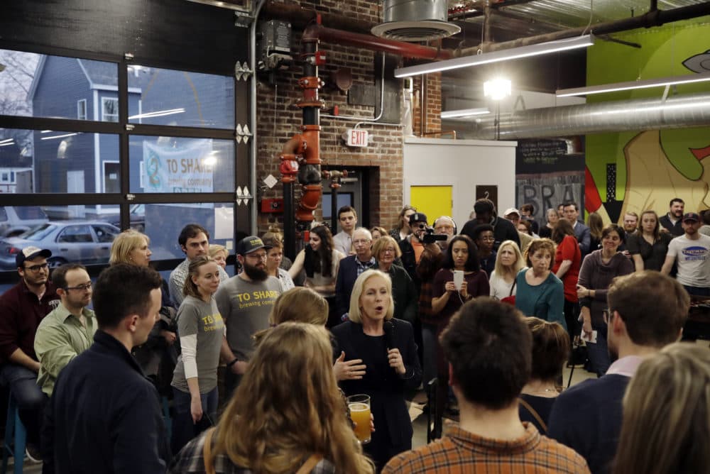 Gillibrand, middle, speaks during a campaign meet-and-greet on March 15 at To Share Brewing in Manchester, N.H. (Elise Amendola/AP)