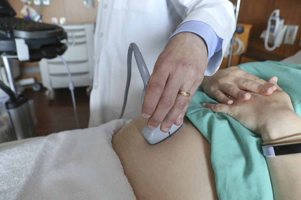 A doctor performs an ultrasound scan on a pregnant woman at a hospital in Chicago. (Teresa Crawford/AP)