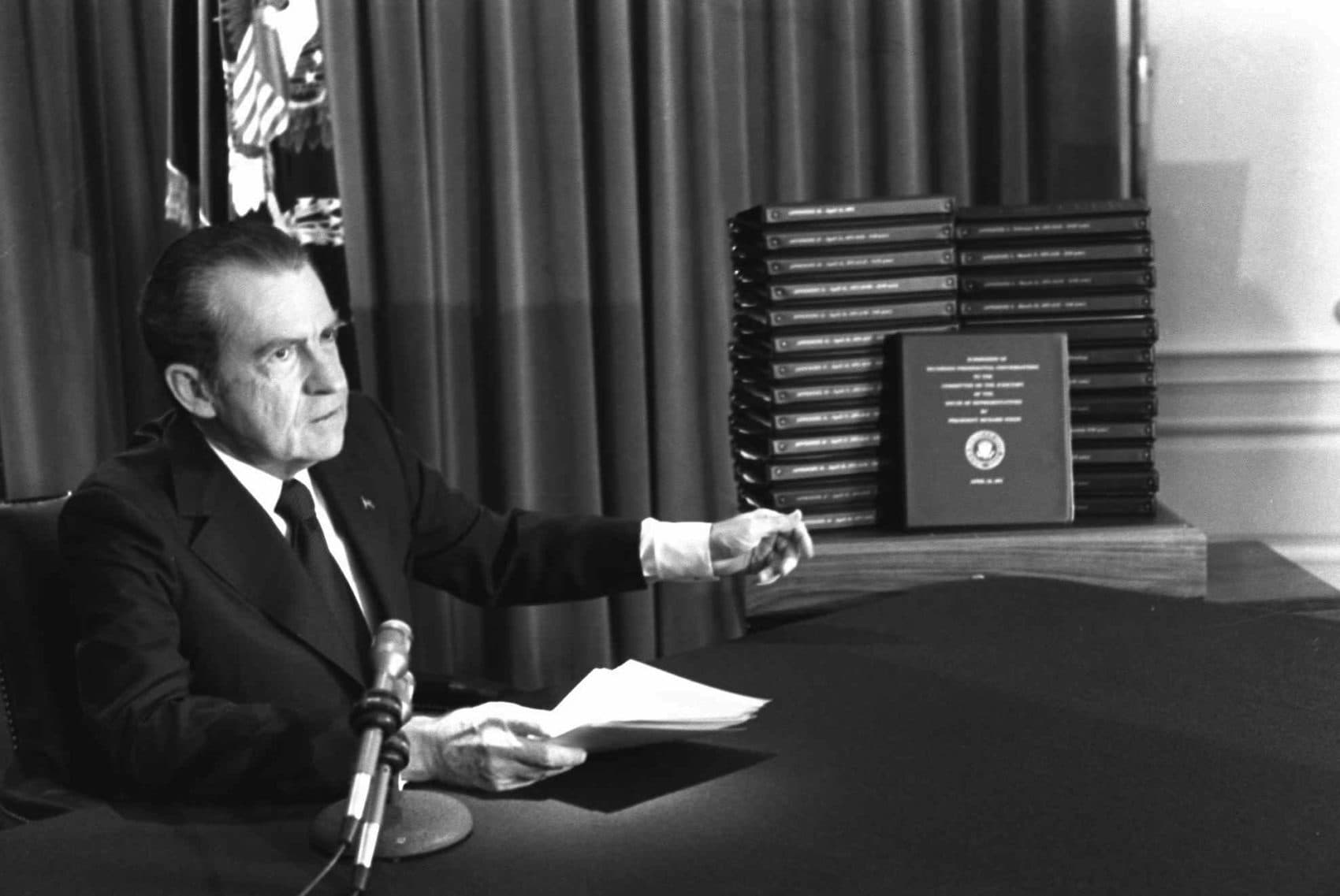 President Nixon gestures toward transcripts of White House tapes after announcing he would turn them over to House impeachment investigators and make them public in April 1974. (AP Photo)