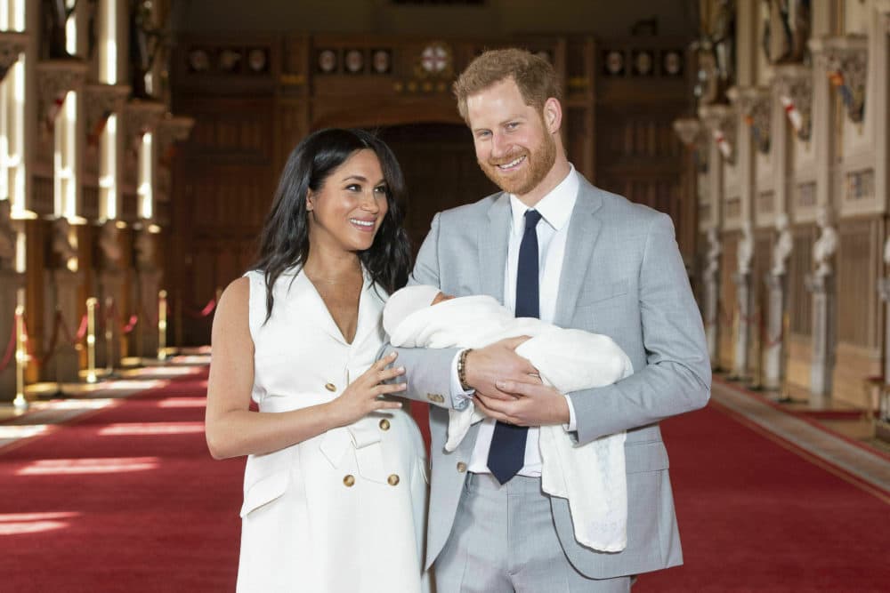 Britain's Prince Harry and Meghan, Duchess of Sussex, during a photocall with their newborn son, in St George's Hall at Windsor Castle, Windsor, south England, Wednesday May 8, 2019. (Dominic Lipinski/Pool via AP)