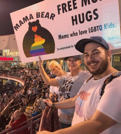 Sara Cunningham, center, with her son, Parker Cunningham. Sara is holding a sign for her LGBTQ moms organization. (Courtesy Parker Cunningham)