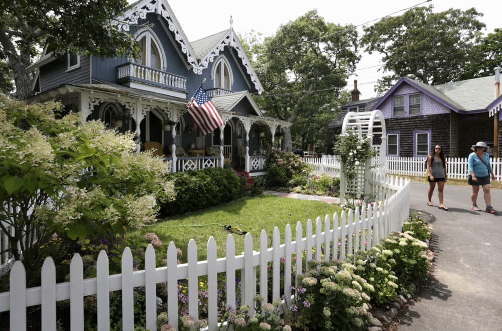 In this 2015 file photo, people walk near cottages in the Camp Meeting Association neighborhood of Oak Bluffs on the island of Martha's Vineyard. (Steven Senne/AP)