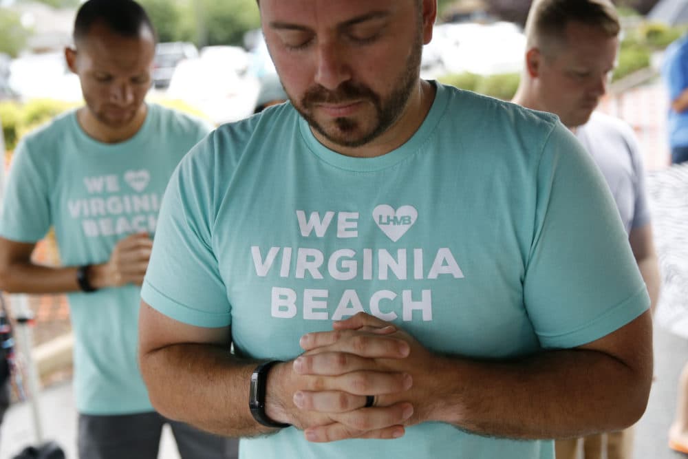 People gather to pray during a vigil in response to a fatal shooting at a municipal building in Virginia Beach, Va., Saturday, June 1, 2019.  (Patrick Semansky/AP)