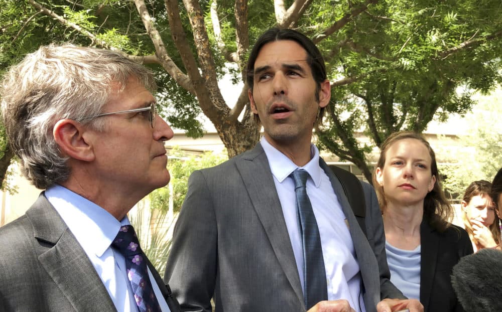 Scott Warren, center, speaks outside federal court, Tuesday, June 11, 2019. in Tucson, Ariz., after a mistrial was declared in the federal case against him. (Astrid Galvan/AP)