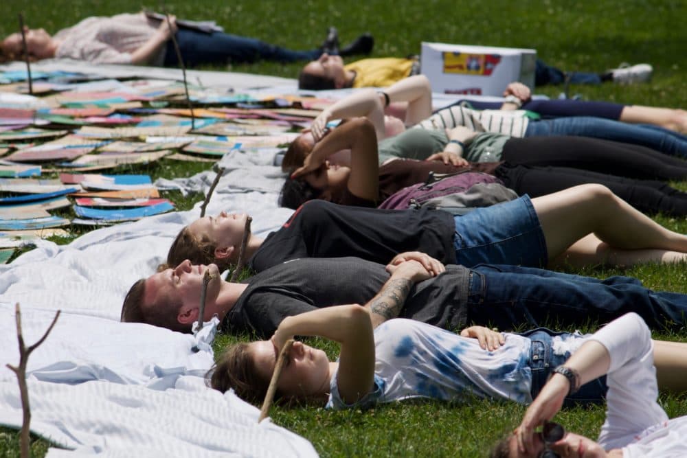 After completing the whale, youth activists pose for a drone photograph. (Miriam Wasser/WBUR)