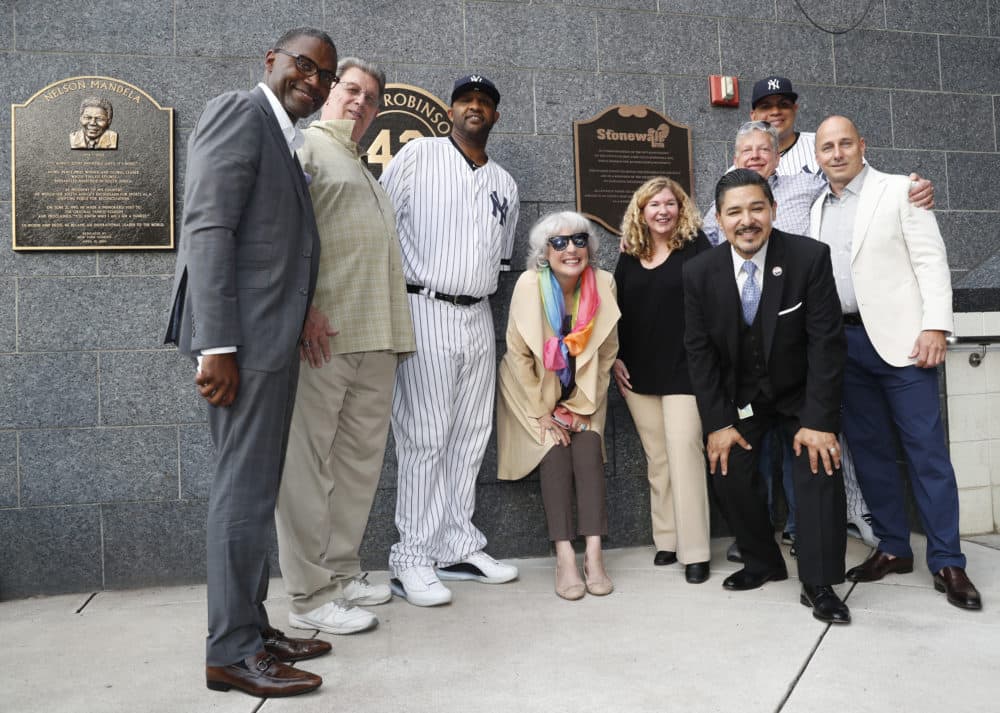 Representatives of the the Stonewall Inn and the New York Yankees honor the 50th anniversary of the Stonewall uprising after the Yankees unveiled a plaque in Monument Park Tuesday, June 25, 2019, in New York City. (Kathy Willens/AP)
