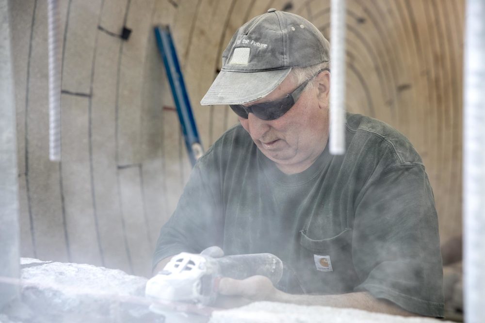 Gordon Wilton, 72, from Biggin by Hartington in Derbyshire, works on a wall at "Watershed." (Robin Lubbock/WBUR)