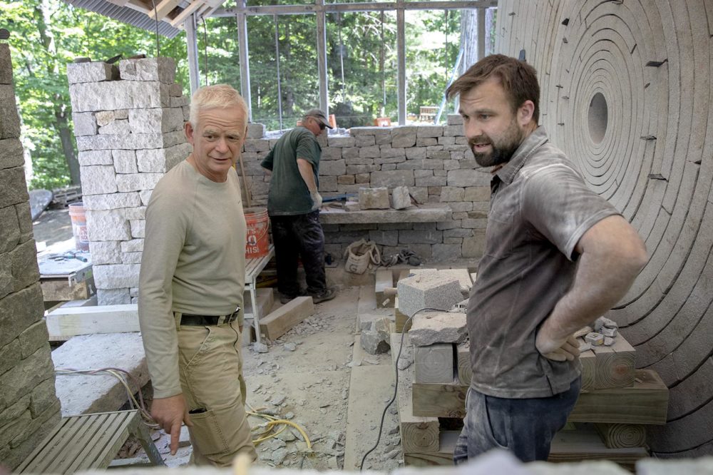 Artist Andy Goldsworthy talks with members of his crew of dry stone wallers during the construction of "Watershed." (Robin Lubbock/WBUR)