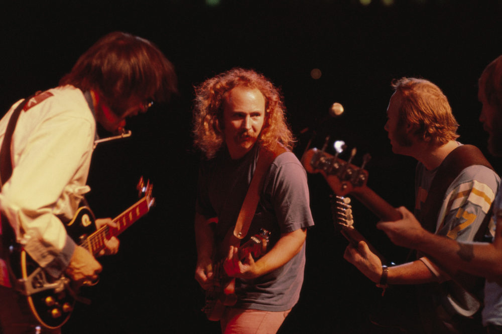 David Crosby (center), jamming with Neil Young (left), Stephen Stills (right) and Tim Drummond (bass), during a Crosby, Stills, Nash & Young concert in 1974. (Courtesy of Sony Pictures Classics)