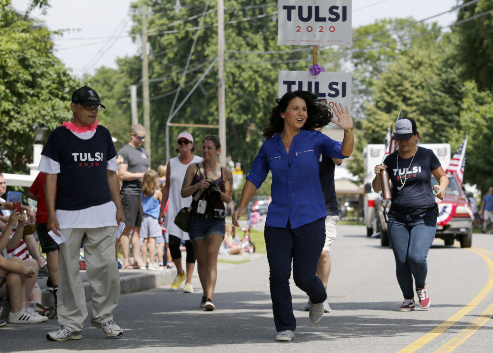 Democratic presidential candidate U.S. Rep. Tulsi Gabbard, D-Hawaii, waves as she runs along the route during the Fourth of July Parade in Amherst, N.H. (Mary Schwalm/AP)