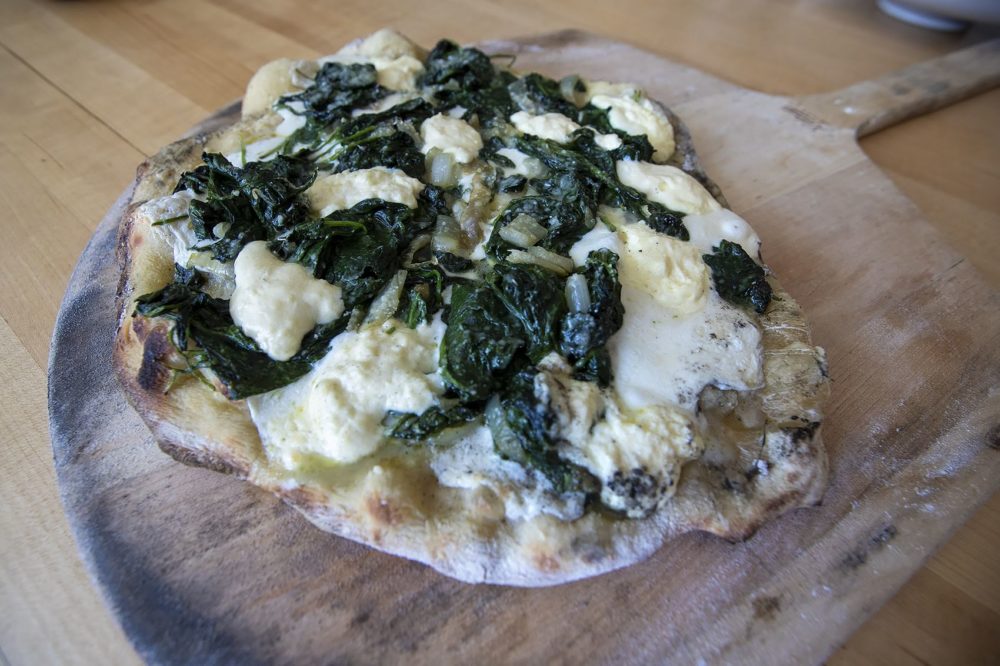 Pizza with spinach, ricotta and mozzarella. (Jesse Costa/WBUR)