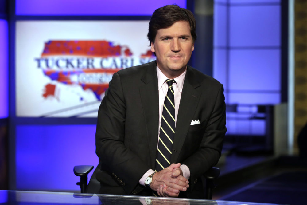 In this March 2, 2017 file photo, Fox News host Tucker Carlson poses for photos in a Fox News Channel studio in New York. (Richard Drew/AP)