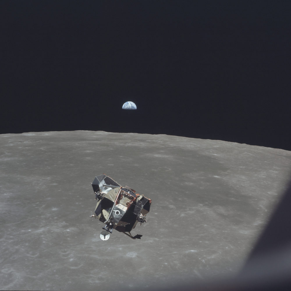 In this July 21, 1969 photo, the Apollo 11 Lunar Module ascent stage, carrying astronauts Neil Armstrong and Buzz Aldrin, approaches the Command and Service Modules for docking in lunar orbit. In the background the Earth rises above the lunar horizon. (Michael Collins/NASA via AP)