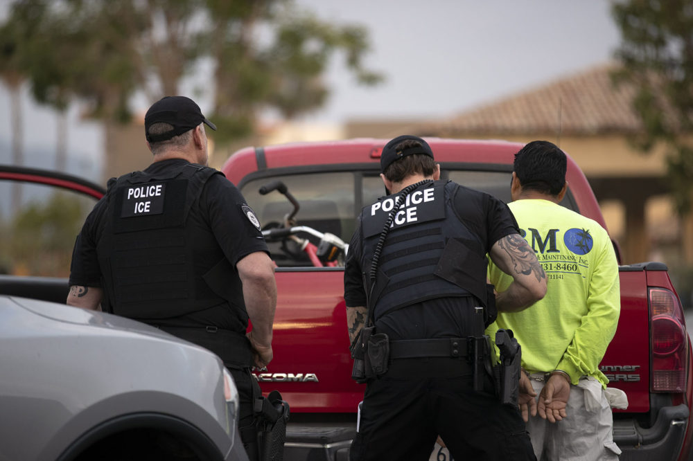 In this July 8, 2019, photo, a U.S. Immigration and Customs Enforcement (ICE) officers detain a man during an operation in Escondido, Calif. (Gregory Bull/AP)