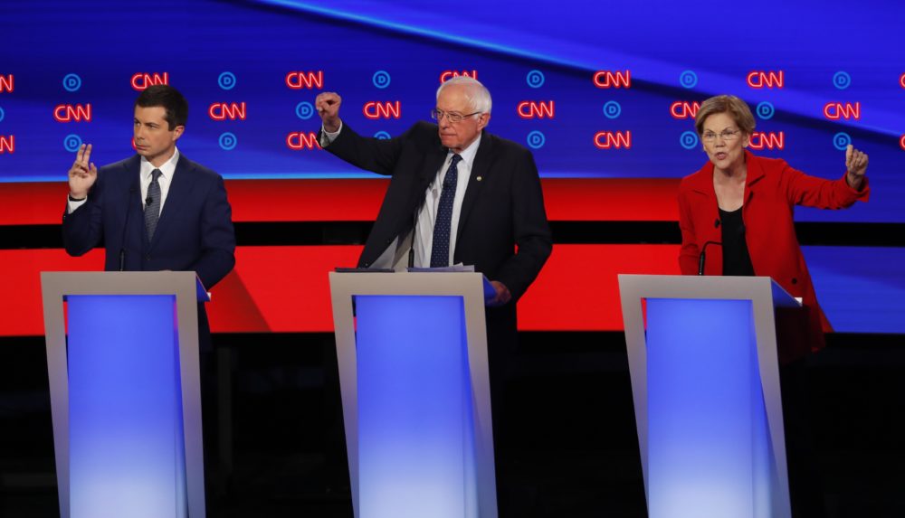 South Bend Mayor Pete Buttigieg, left, and Sen. Elizabeth Warren, seen here in Tuesday's Democratic debate, topped the fundraising list in Massachusetts last quarter. (Paul Sancya/AP)