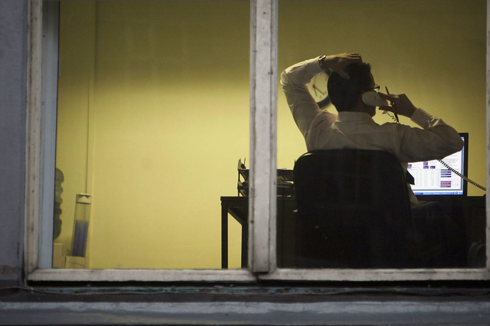 A city office employee works into the night as darkness closes in on October 10, 2005 in Glasgow, Scotland. (Christopher Furlong/Getty Images)