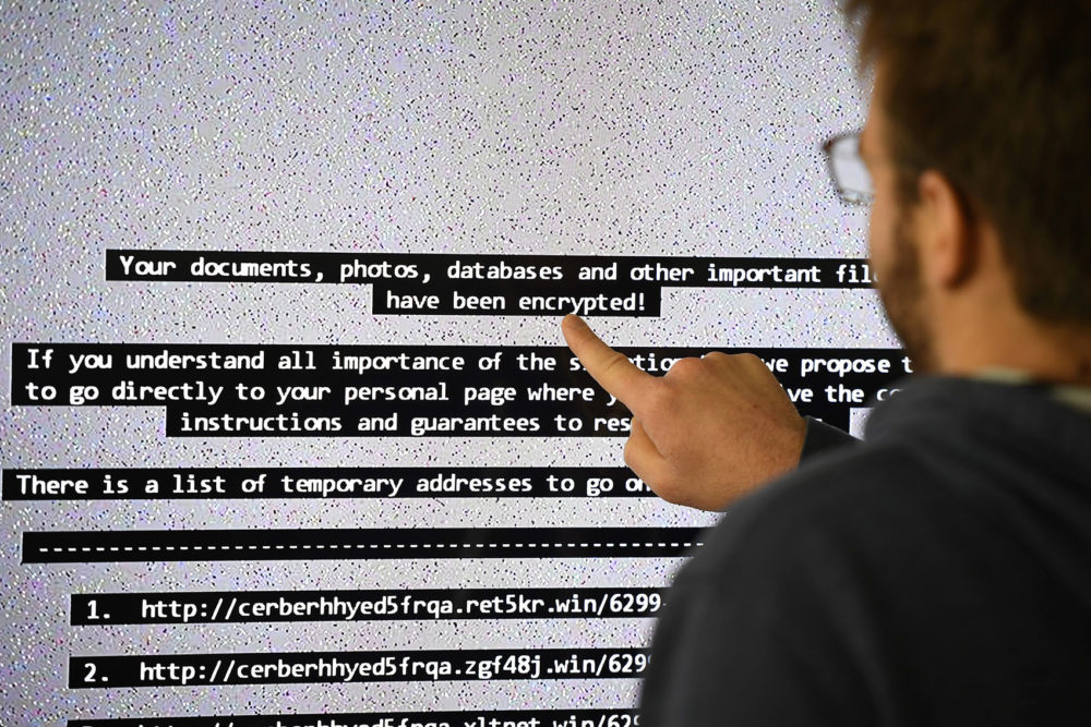 An IT researcher shows on a giant screen a computer infected by a ransomware in Rennes, France on Nov. 3, 2016. (Damien Meyer/AFP/Getty Images)