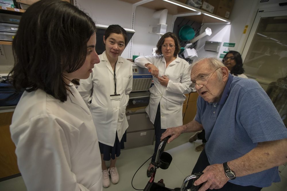Jack Strominger consults with his team about a pending grant. Left to right: Angela Crespo, Qin Li, Tamara Tilburgs, Strominger (front), Sarika Kshirsagar (back).(Jesse Costa/WBUR)