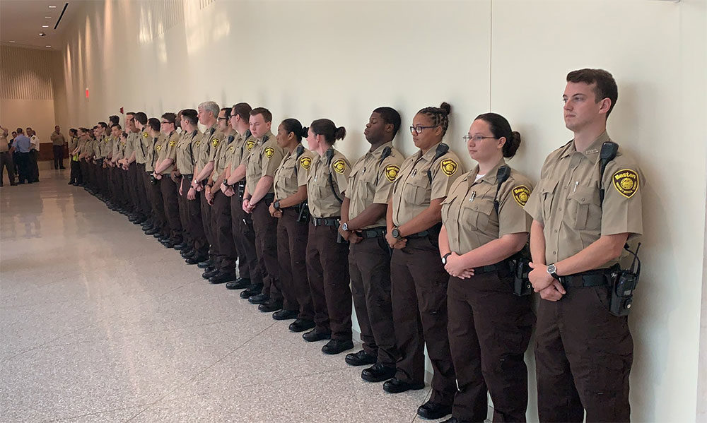 Dozens of Boston EMS personnel stand outside Boston Municipal Court Thursday for the arraignment of a suspect accused of stabbing an EMT. (Steve Brown/WBUR)