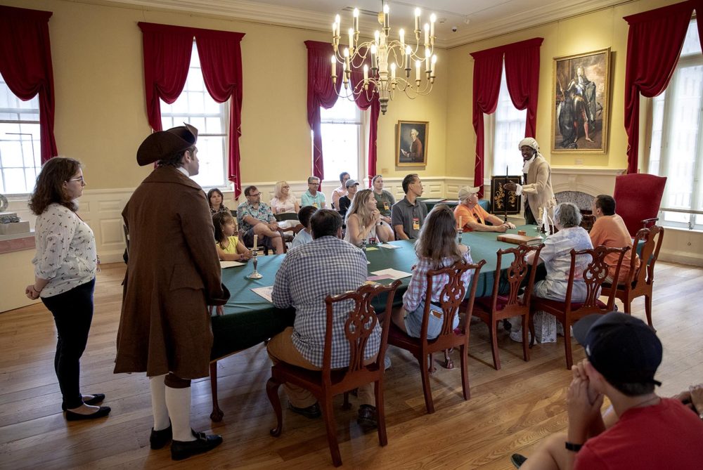 Actors Alex Jacobs and Stephen Sampson perform "The Petition" for an audience at the Old State House in Boston. (Robin Lubbock/WBUR)