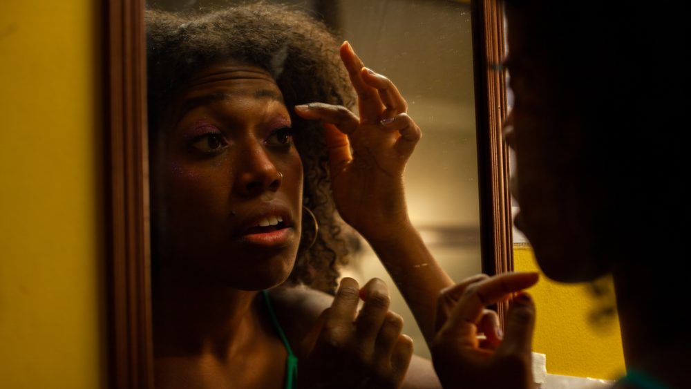 Kristin Haynes, who performs as a Disco Girl, applies her false eyelashes before hitting the stage. (OJ Slaughter for WBUR)
