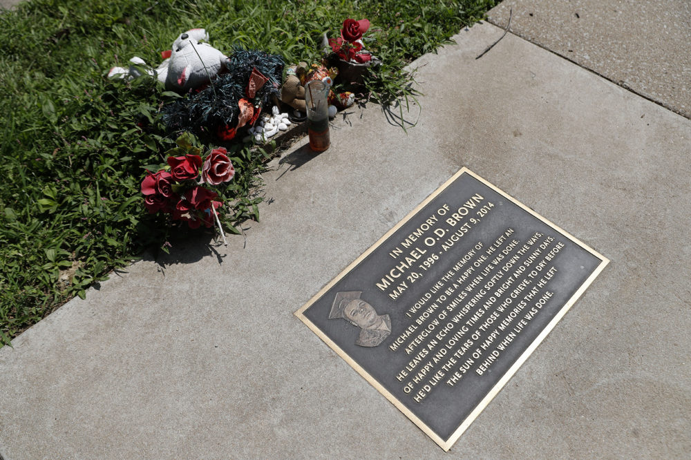 In this July 25, 2019, photo, flowers and other items lay near a memorial plaque in the sidewalk near the spot where Michael Brown was shot and killed by a police officer five years ago in Ferguson, Mo. (Jeff Roberson/AP)