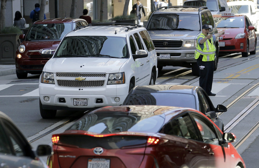 In this 2017 file photo, a San Francisco Municipal Transit Agency officer directs traffic in San Francisco. (Jeff Chiu/AP)