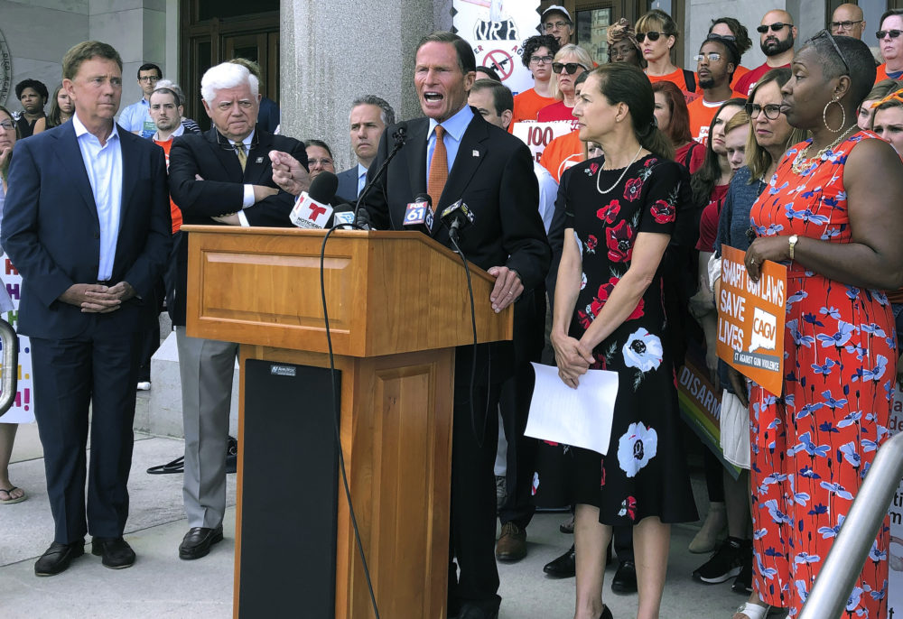 Senator Richard Blumenthal, center, speaks Monday, Aug. 5, 2019, outside the Capitol in Hartford, Conn., surrounded by Connecticut Gov. Ned Lamont, left, U.S. Rep. John Larson, second from left, Lt. Gov. Susan Bysiewicz, second from right, and state Rep. Robyn Porter, D-New Haven, right. The political delegation and gun safety groups rallied to urge the U.S. Senate to return immediately to Washington and follow the state's lead in passing stricter gun laws. (Susan Haigh/AP)