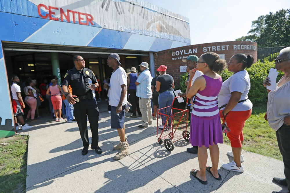 A line forms in front of the Bolan Street Recreation center as Newark residents picked up cases of bottled water, Monday, Aug. 12, 2019, in Newark, N.J., after U.S. Environmental Protection Agency revealed that recent tests showed elevated lead levels in drinking water in a few locations despite filters that had been distributed earlier. The EPA warned that "out of an abundance of caution" residents should use bottled water for drinking and cooking. People exiting the facility said they had waited two to three hours for the water. (Kathy Willens/AP)