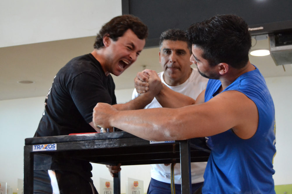 Tomás Silva (left) competes at an arm-wrestling competition in Chile. (Paige Sutherland for WBUR)