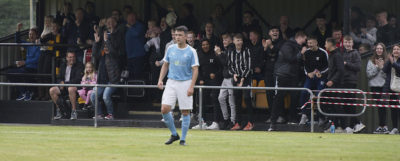 A Nairn player looks on in disbelief as local fans cheer on a Fort William goal. (Iain Ferguson, The Write Image)