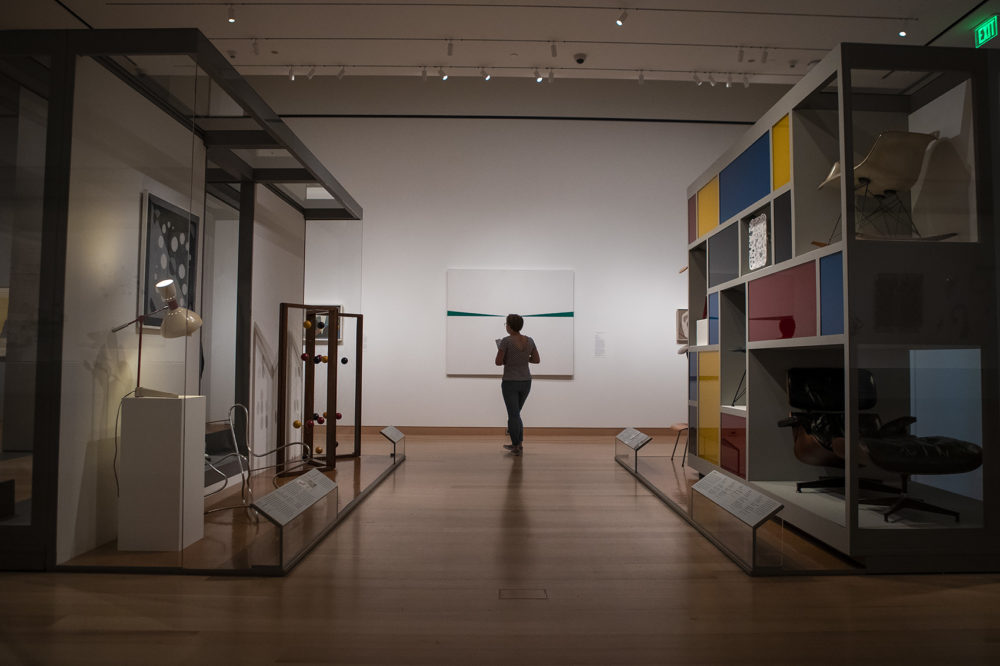 A women examines Carmen Herrera’s “Blanco y Verde." (Jesse Costa/WBUR)