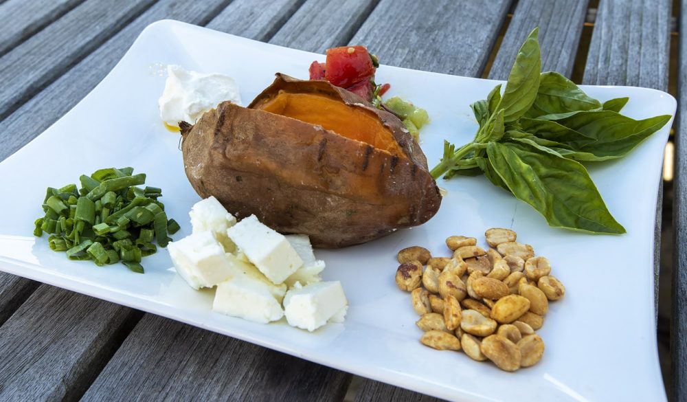 Baked sweet potatoes with all the toppings. (Jesse Costa/WBUR)