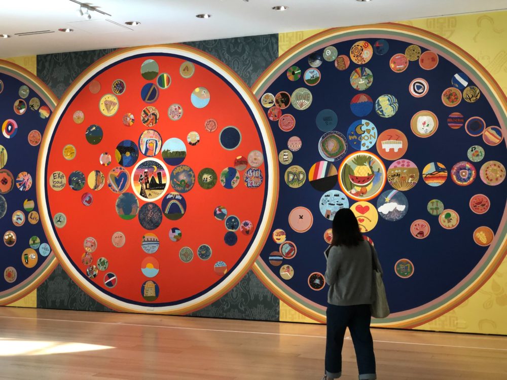 A visitor walks by "Mindful Mandalas" in the Linde Gallery at the MFA. (Courtesy)