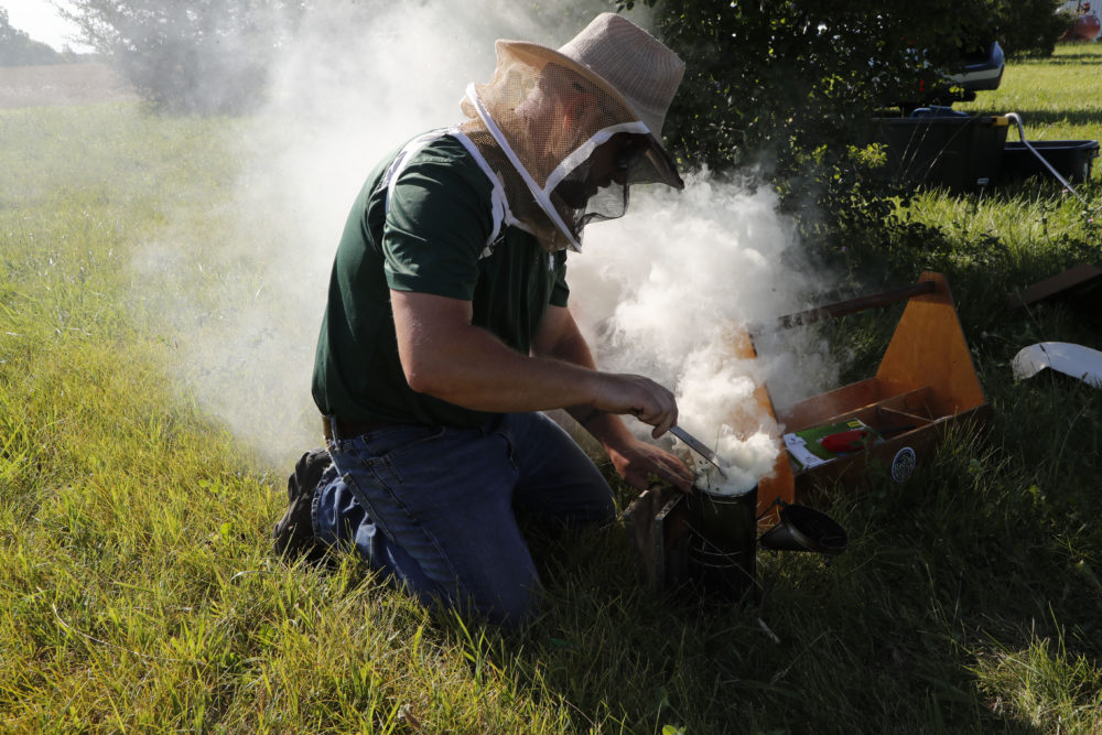 Ingrao prepares a bee smoker at the Henry Ford farm in Superior Township, Mich. (Carlos Osorio/AP)