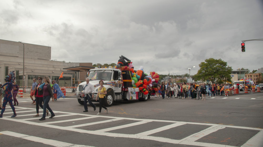 As the parade enters Dudley Square, new performers join in the procession. (OJ Slaughter for WBUR)