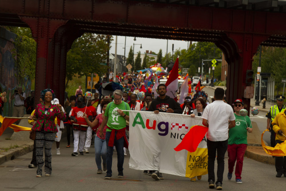 The parade makes its way under the Upham's Corner Commuter Rail overpass. (Courtesy Chris Rogers)