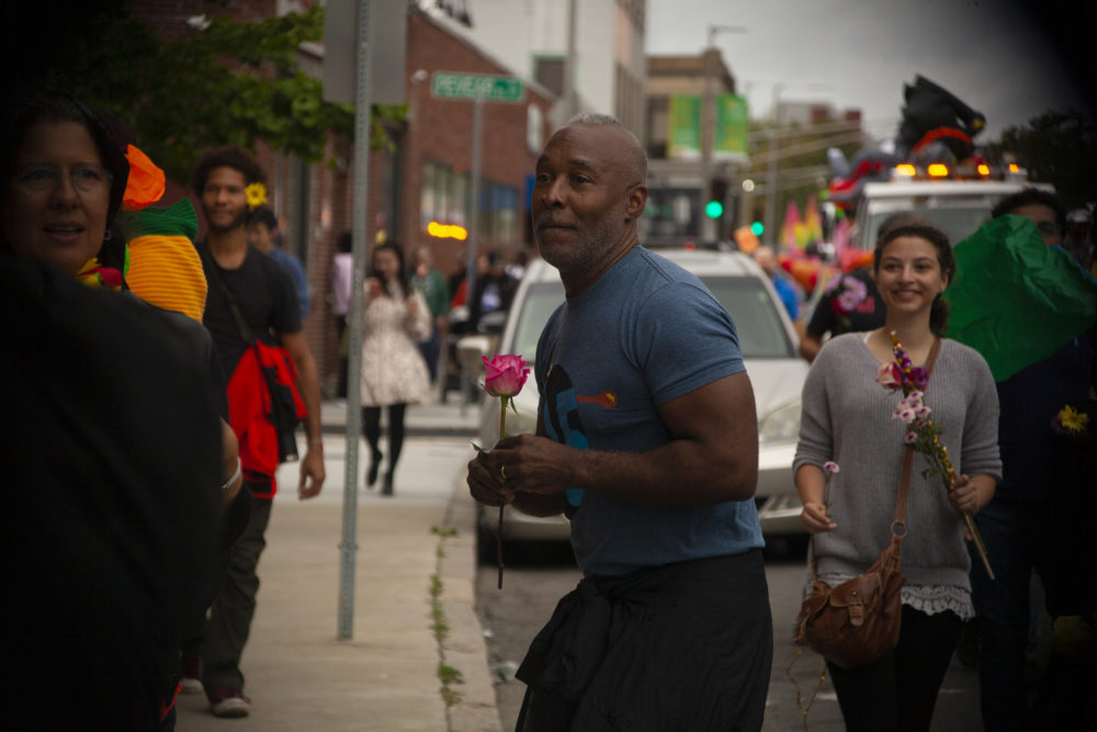 Nick Cave hands out roses to people passing by. (OJ Slaughter for WBUR)