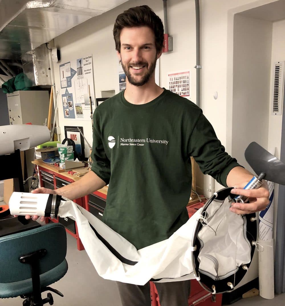 Ethan Edson at the Northeastern University Marine Science Center, holding a plankton net. These nets collect plastic samples on and near the ocean's surface. (Barbara Moran/WBUR)