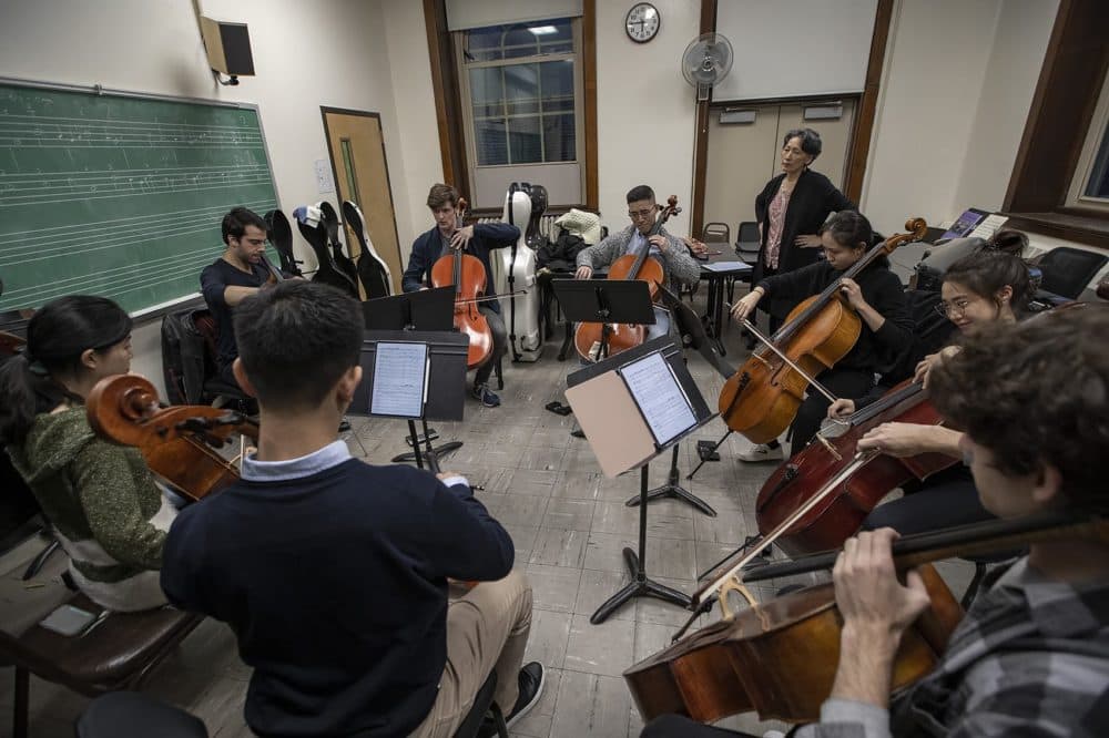 During a recent rehearsal at the New England Conservatory, Yeesun Kim listens to students who will be part of a 56 cello orchestra playing Bach's Cello Suites for a tribute to Pablo Casals. (Jesse Costa/WBUR)